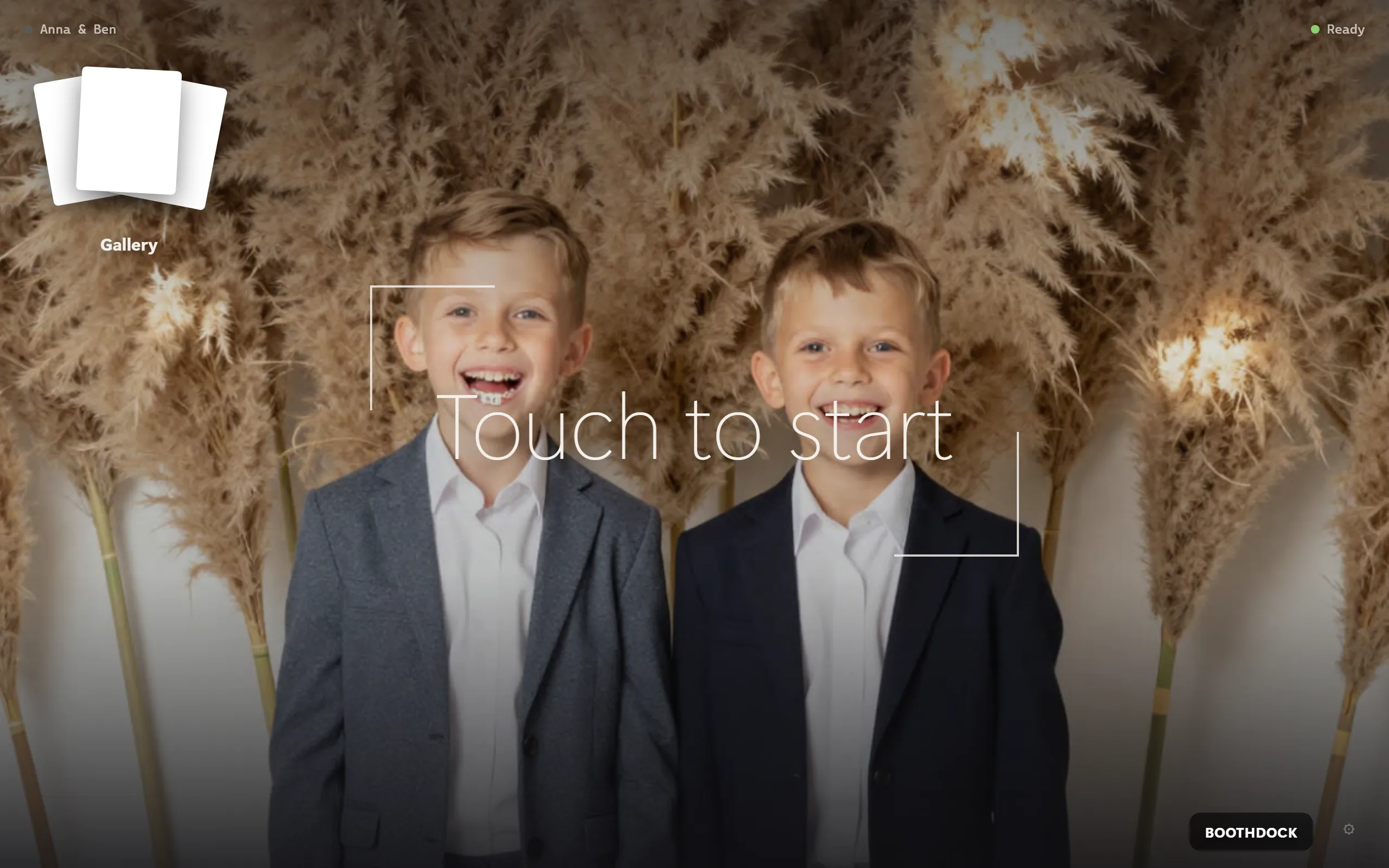 The guest kiosk at the box: "Touch to start" with a live preview